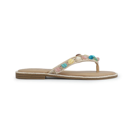 The Vintage Havana Sandy Beige Gemstone Flip Flops feature a tan sole and colorful flower accents on the straps.