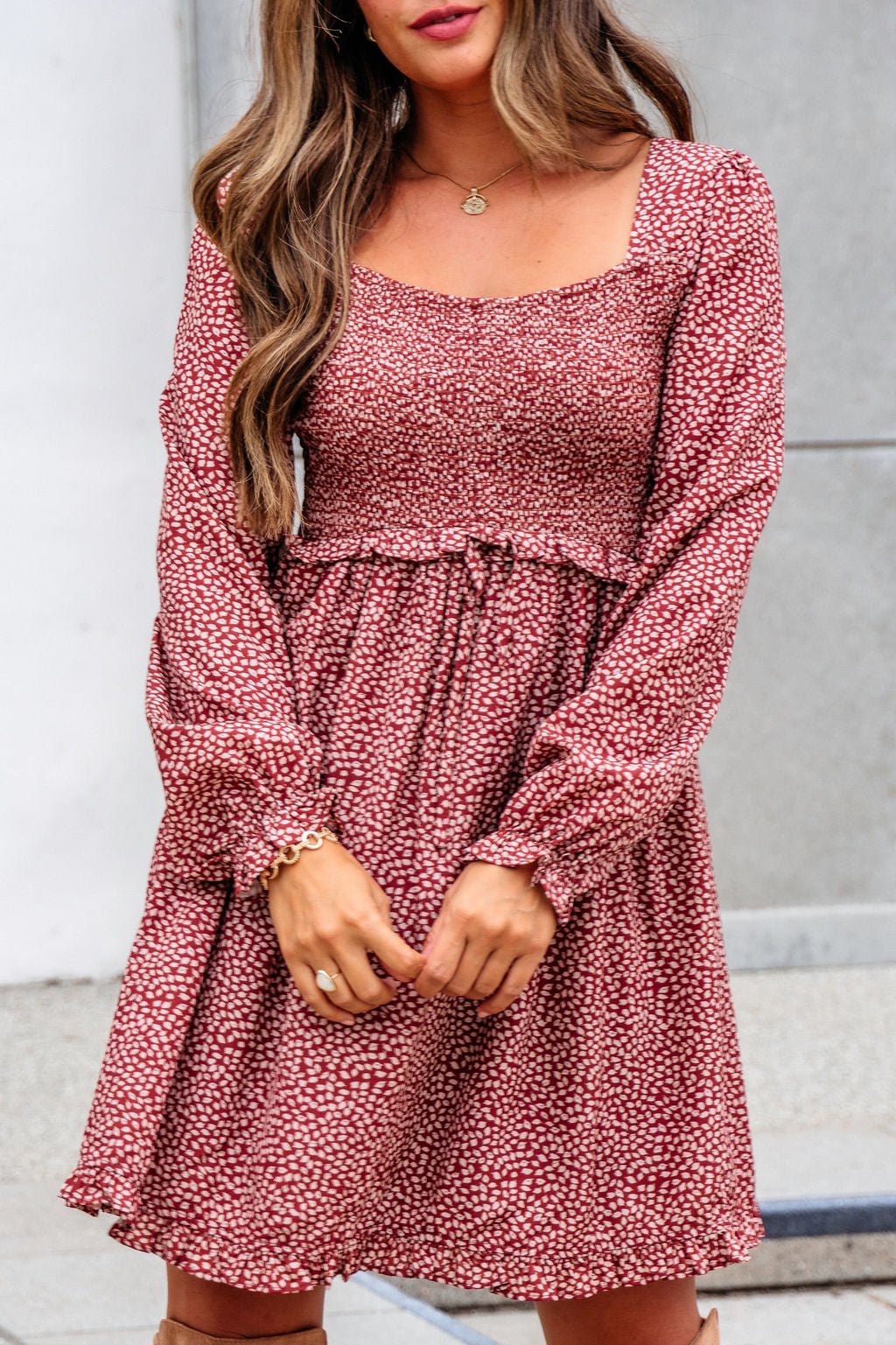 Woman in the Wild Rust Print Smocked Mini Dress - FINAL SALE, outdoors with loose hair and minimal jewelry.