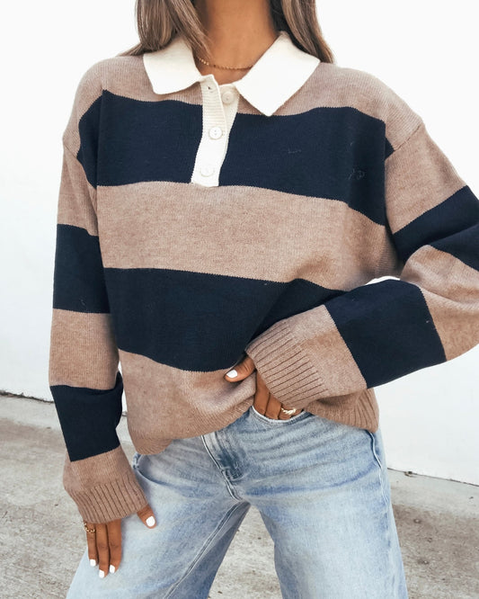 A Striped Sweater - Mocha And Navy with a cream collar and button placket, worn with light-wash jeans.