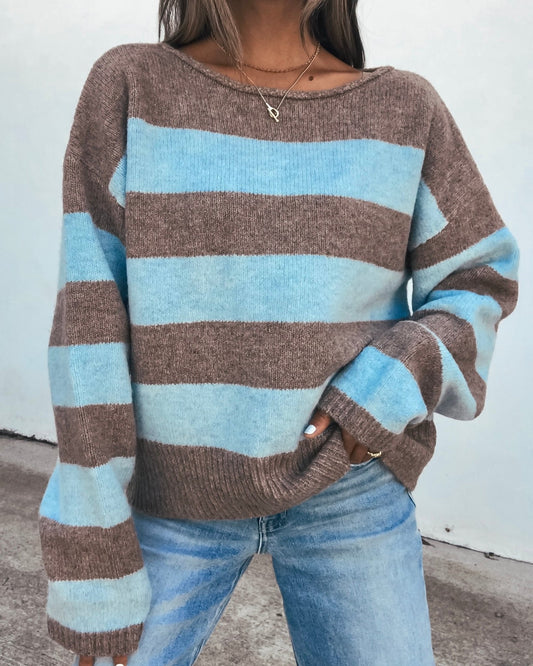 Person wearing an oversized Striped Sweater - Brown And Blue and blue jeans.