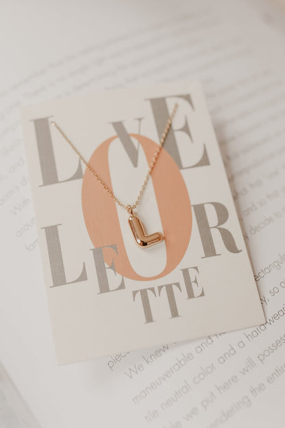 https://magnoliaboutique.com/cdn/shop/products/gold-bubble-letter-pendant-necklace-785887.jpg?v=1698962996&width=416